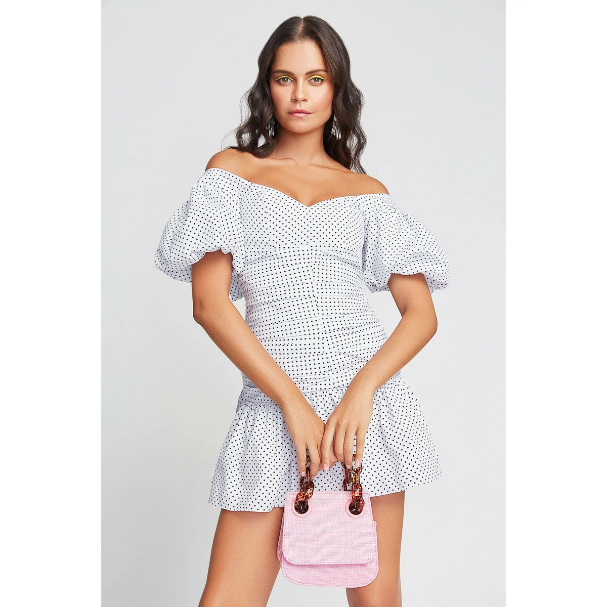 an OnPost model showing the chicest way to wear mini bags for any season