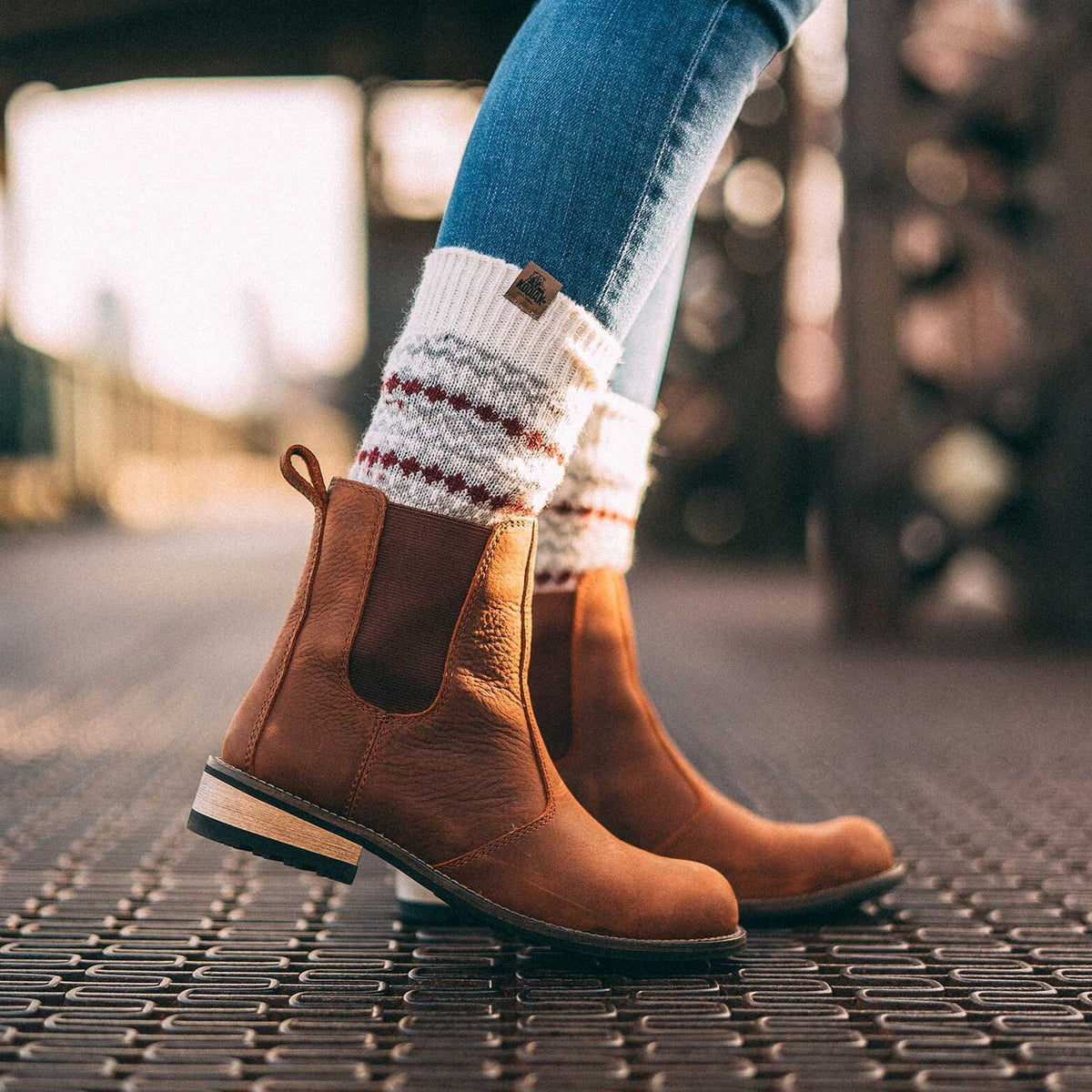a pair of brown boots with warmers and blue skinny jeans in a classical hipster outfit showing how to style Chelsea boots