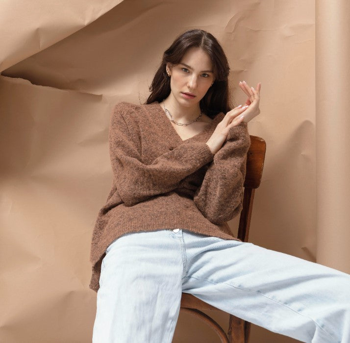 a model showing how to style brown sweaters 