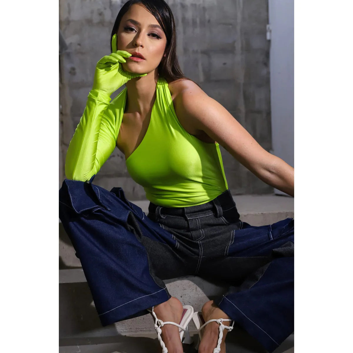 a model showing how to style green in a chic contemporary style with a top and baggy jeans in a OnPost style