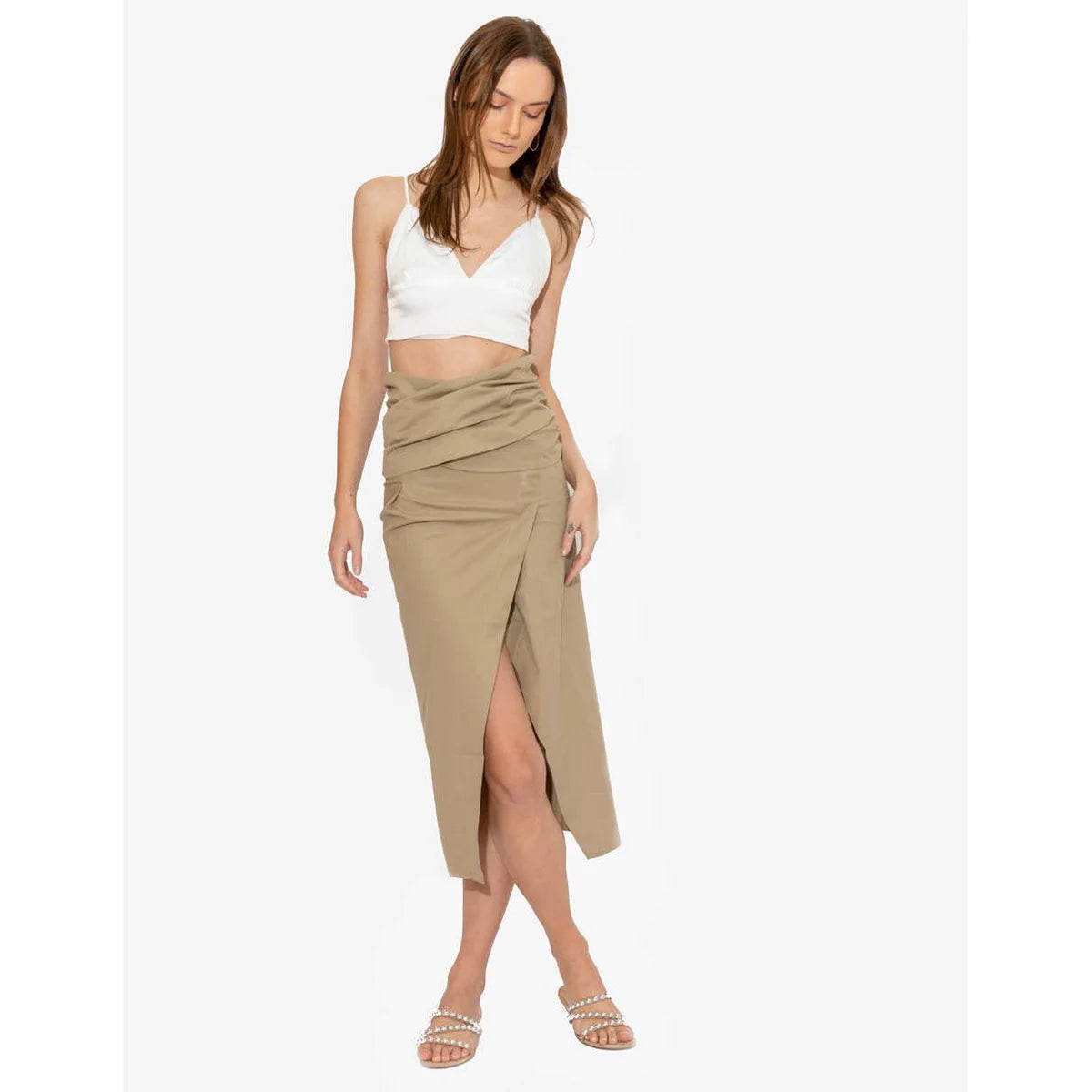 a model styling khaki in long skirt with a white top by OnPost