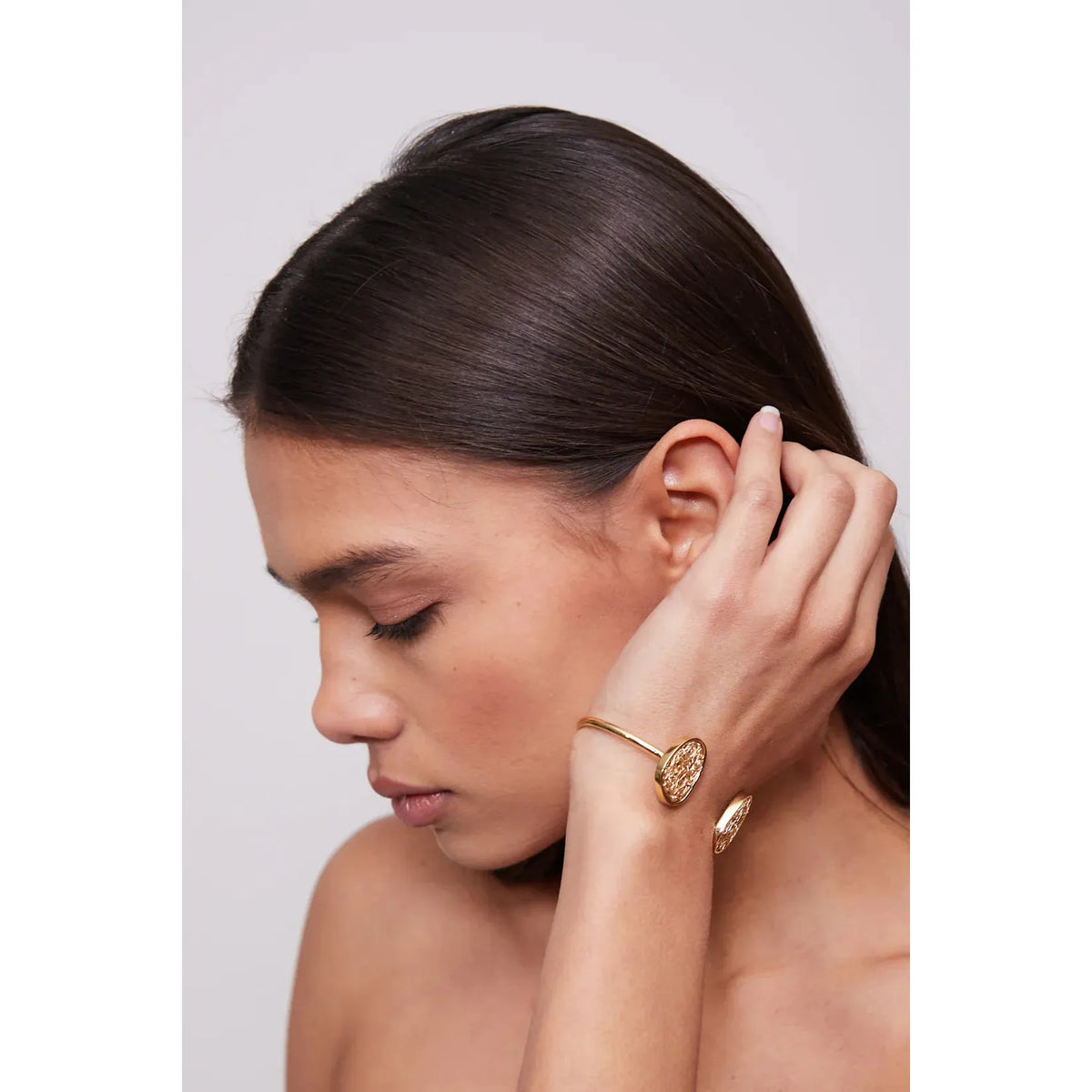 Minimalist and unique gold bracelet, showcasing a sleek and modern silhouette for versatile styling.