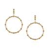 Unique statement gold hoop earrings showcasing a modern silhouette and a touch of artisanal crochet artistry.